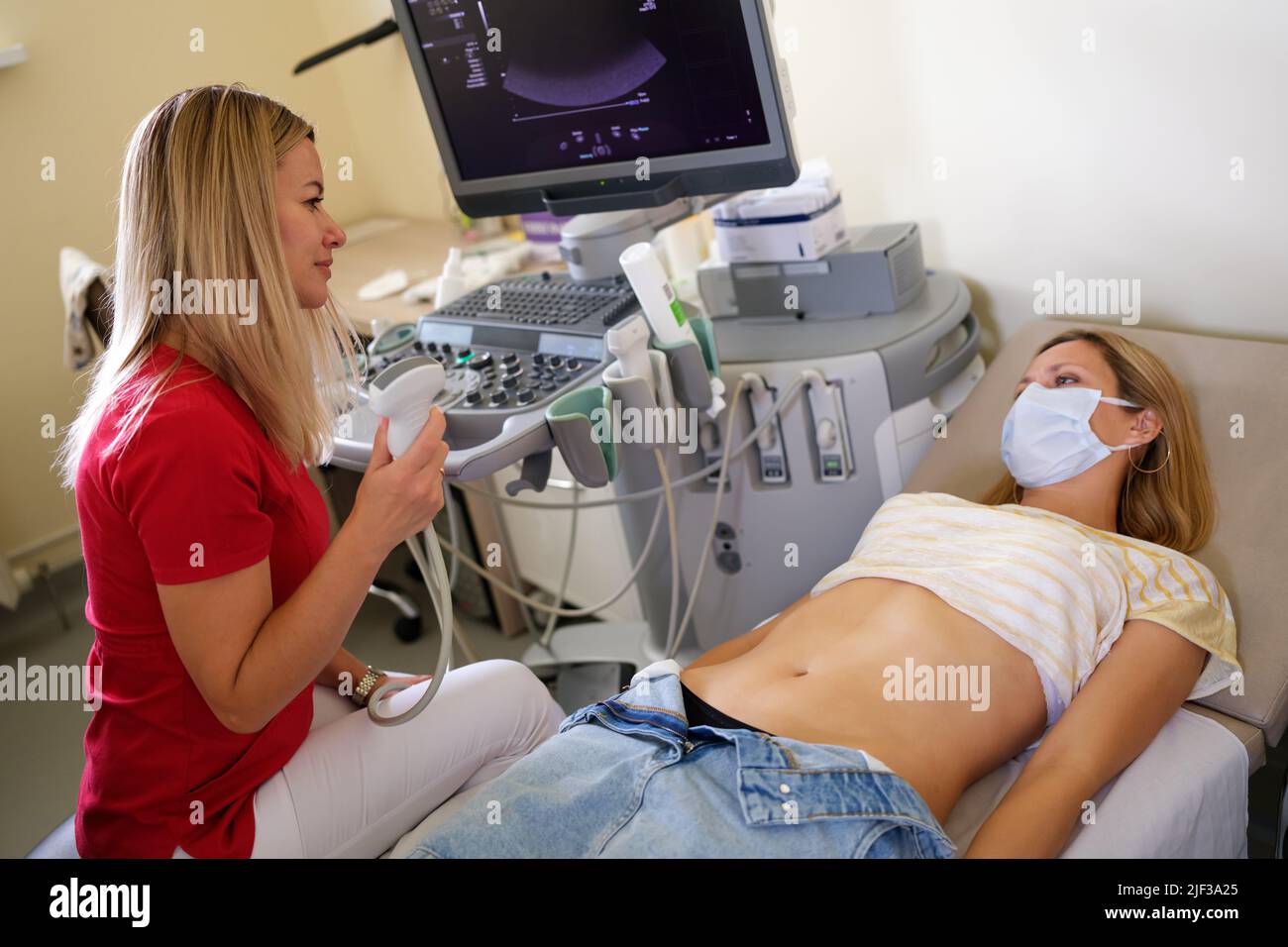 Doctor examines woman with ultrasound scanner closeup Stock Photo - Alamy