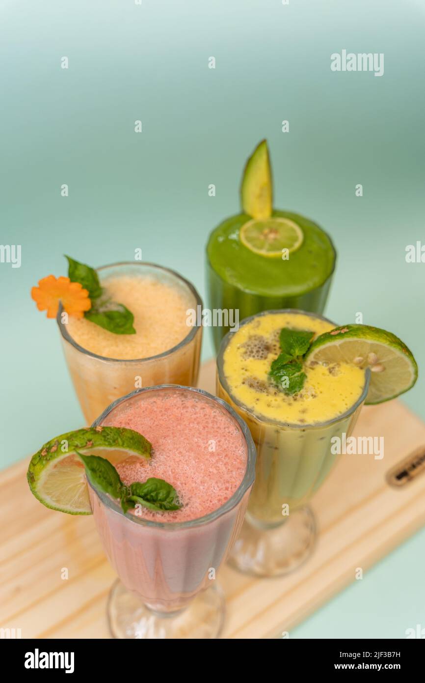 Freshly blended fruit smoothies of various colors and tastes in glass