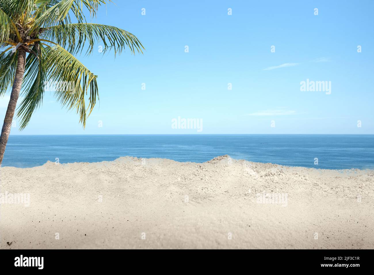 Sandy beach with the blue ocean and blue sky background Stock Photo - Alamy