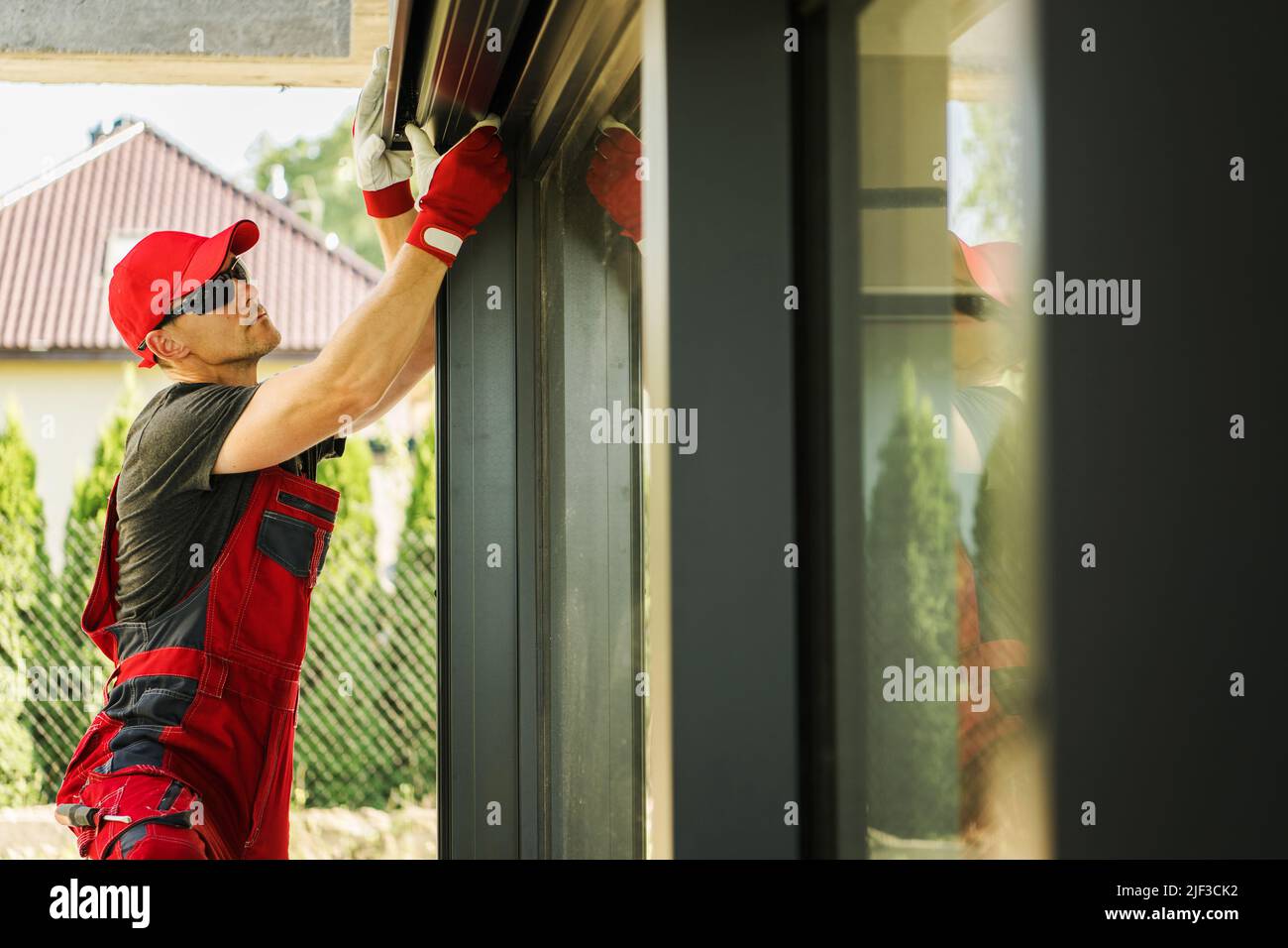Worker Installing Outdoor Sun Shade Electric Roller Shutters in Newly