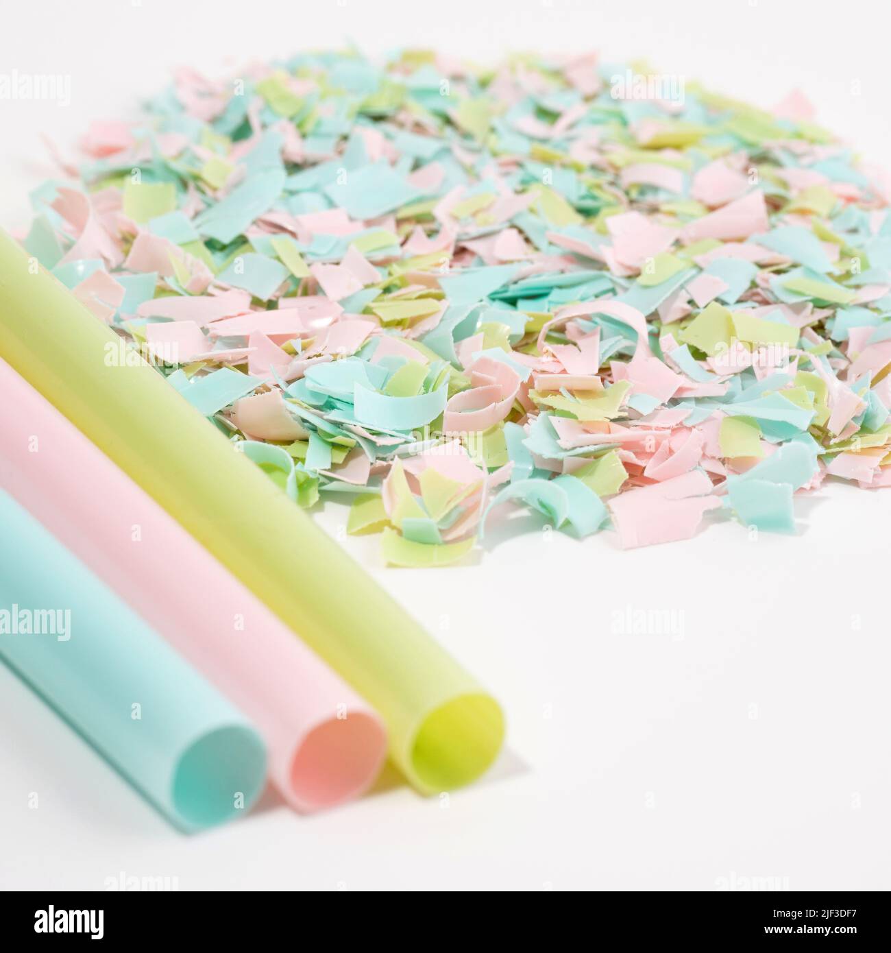 Drinking straws and microplastics on a white background. The idea of micro plastic pollution. Impact of microplastic on the food chain. Concept of env Stock Photo