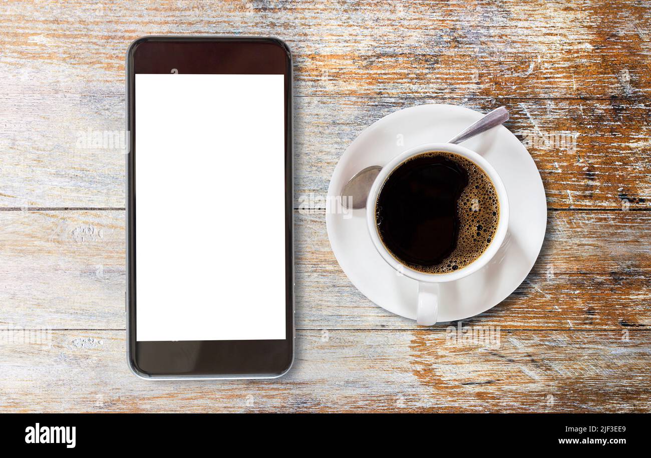 Smart phone with blank screen area and coffee cup on vintage wooden ...
