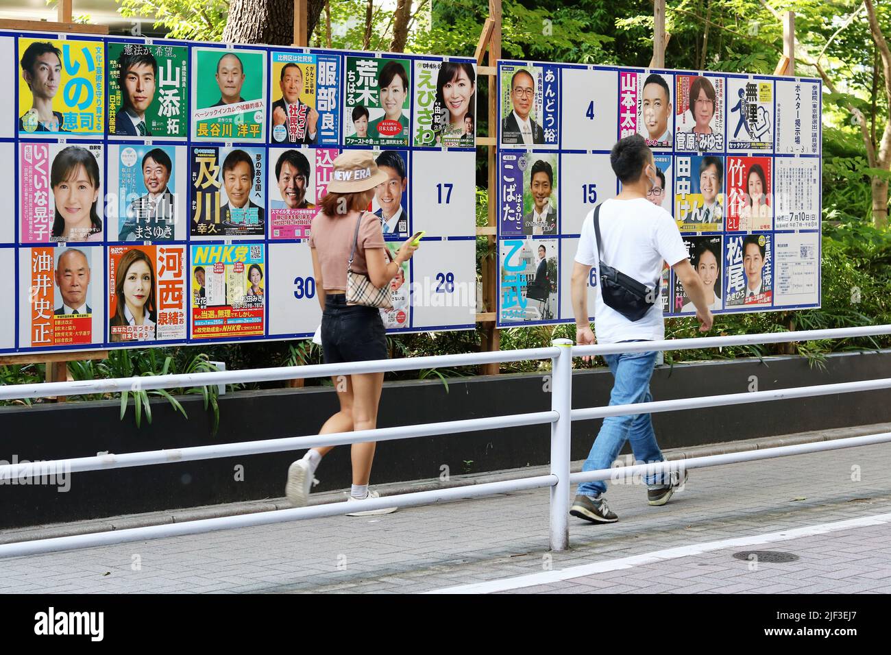 TOKYO, JAPAN June 28, 2022 People pass official noticeboard on a