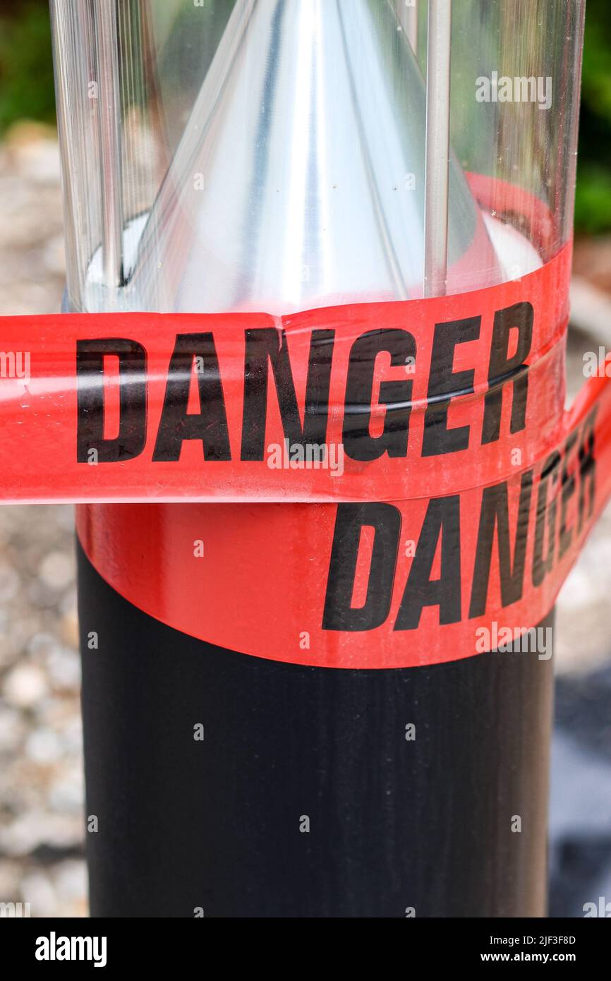 A vertical shot of red Danger warning tape - barricade barrier tape ...