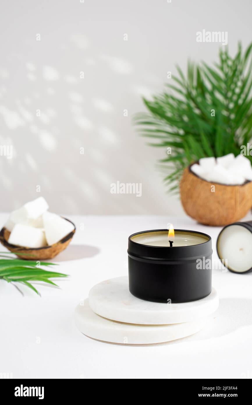 Coconut wax candle in a black jar on a white background. natural eco