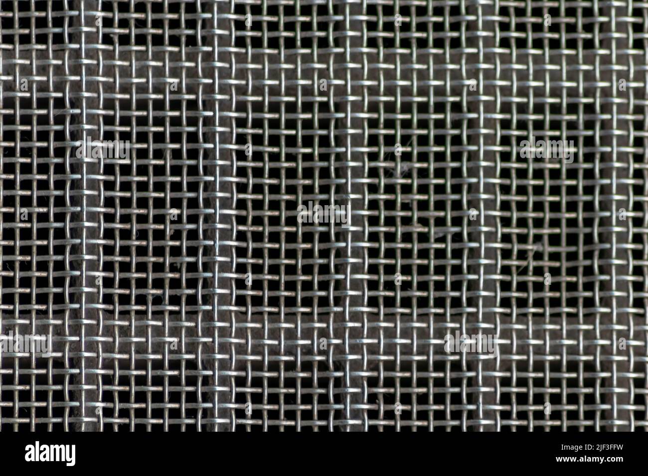 Solid metal mesh over metal grid as solid filter for particles in heavy industry products for durability Stock Photo