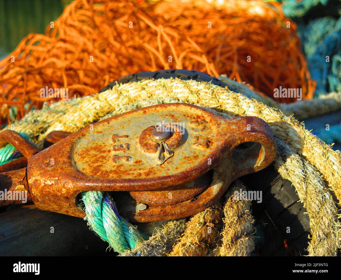 Yellow, rusty and blue mooring lines. Fishing nets, fishing industry