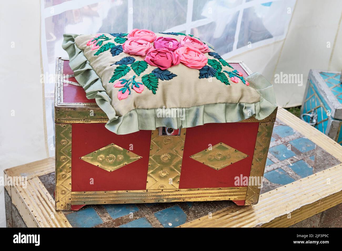 Vintage old Tatar chests and small pillow with floral pattern, embroidered colorful ribbons. Stock Photo