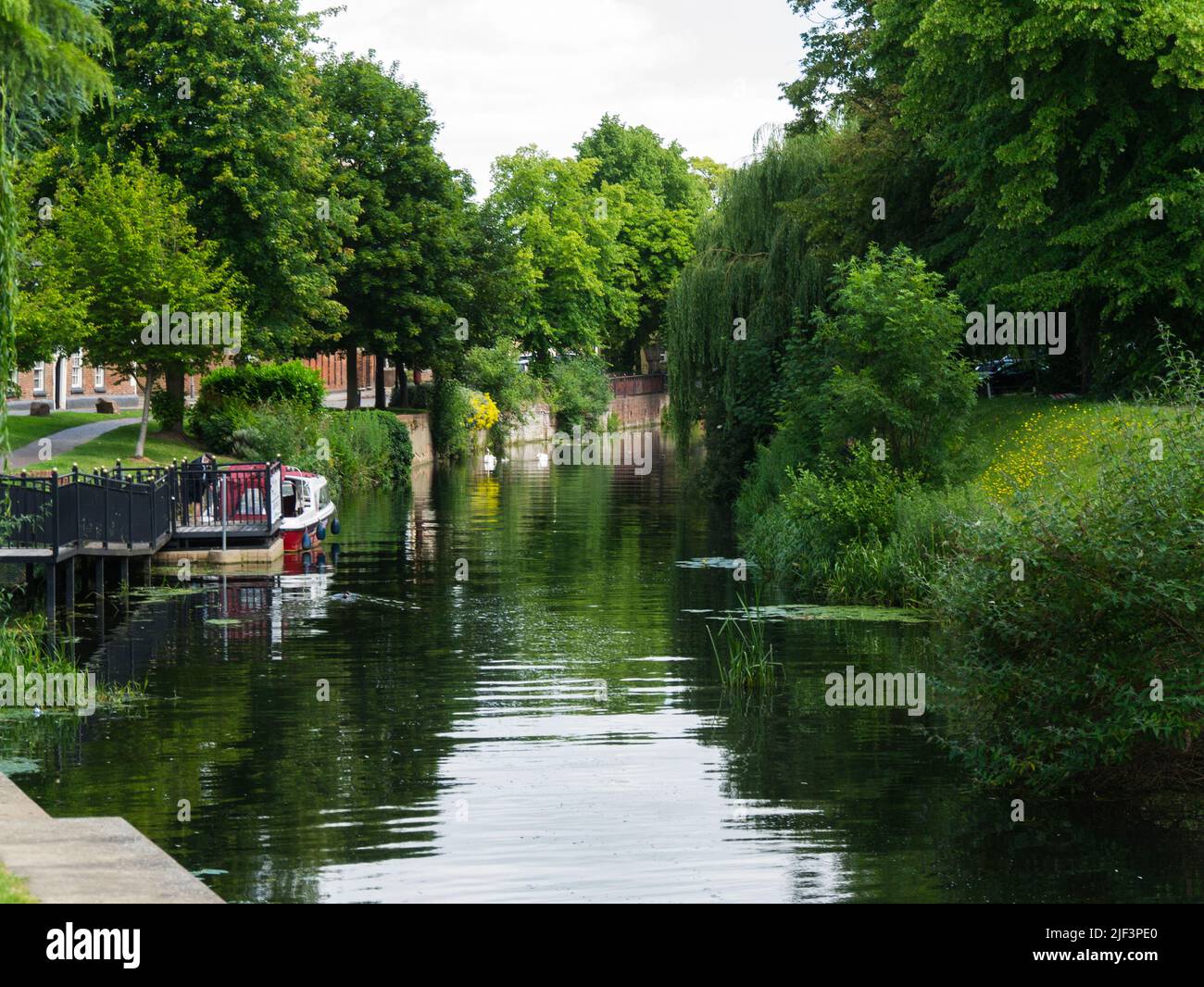 View along River Welland with Spalding Water Taxi moored at town jetty Lincolnshire England UK Stock Photo