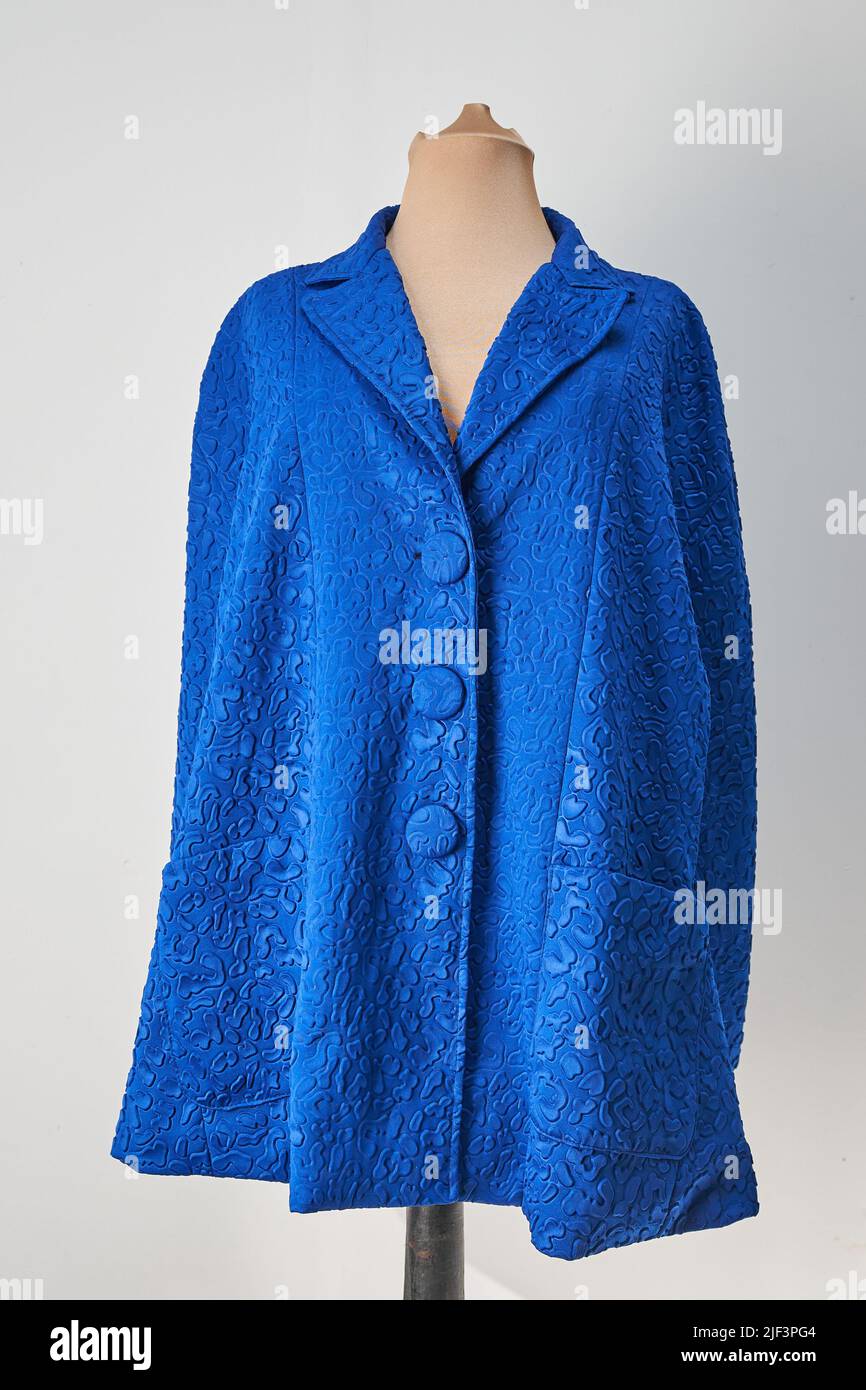 Blue embossed fabric jacket with blue buttons. Formal wear, autumn coat Stock Photo