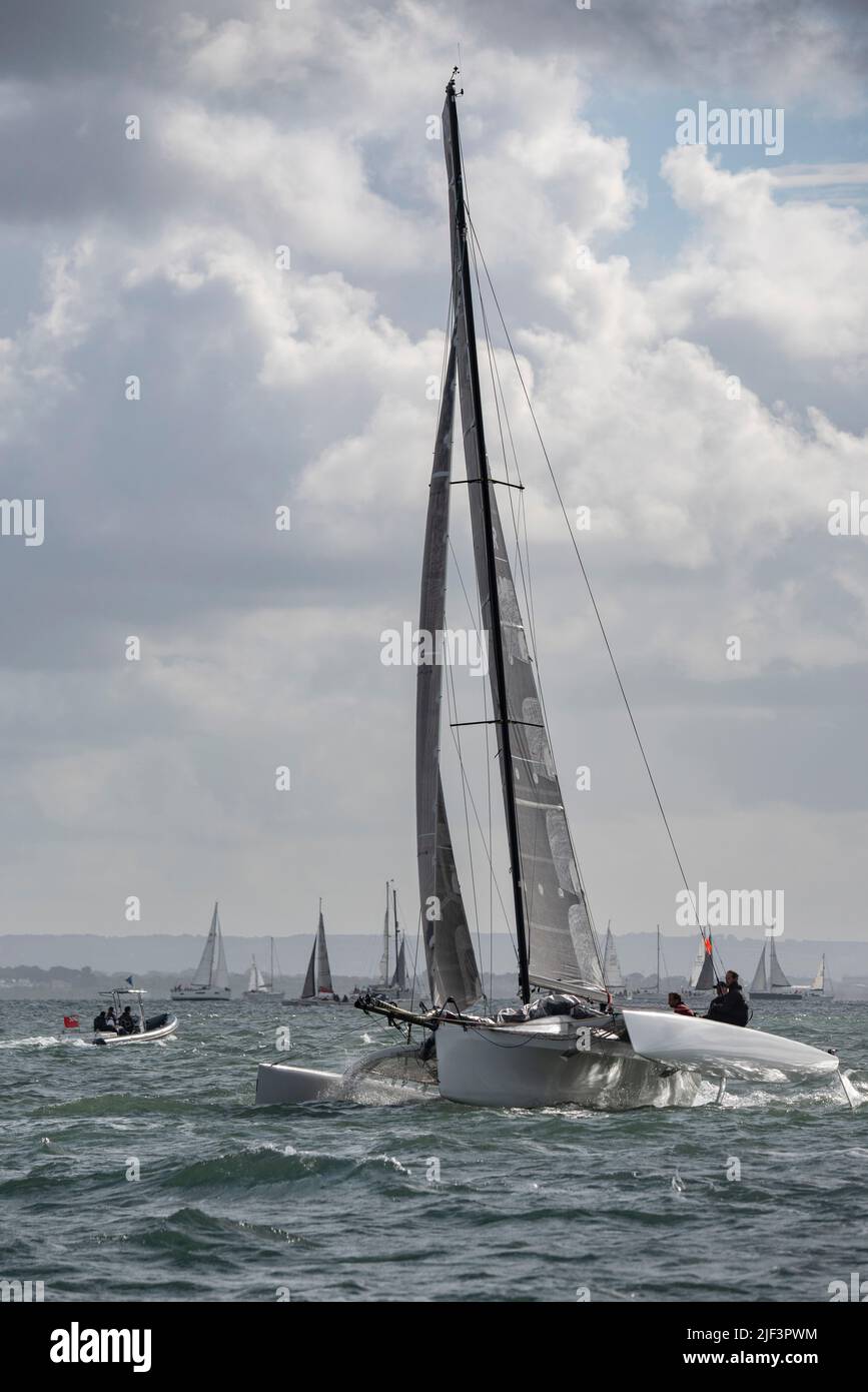 Race Winner Julian Linton's Farrier 32 Trimaran N.R.B. gets off to a flying start at the Isle of Wight Sailing Club's Round The Island Race Stock Photo
