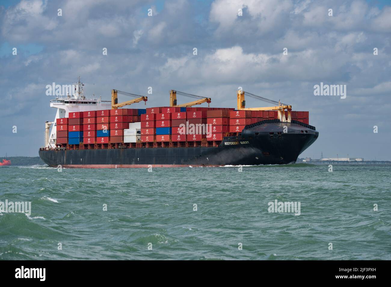 Container Ship Independent Quest sailing East along The Solent in Southern England Stock Photo