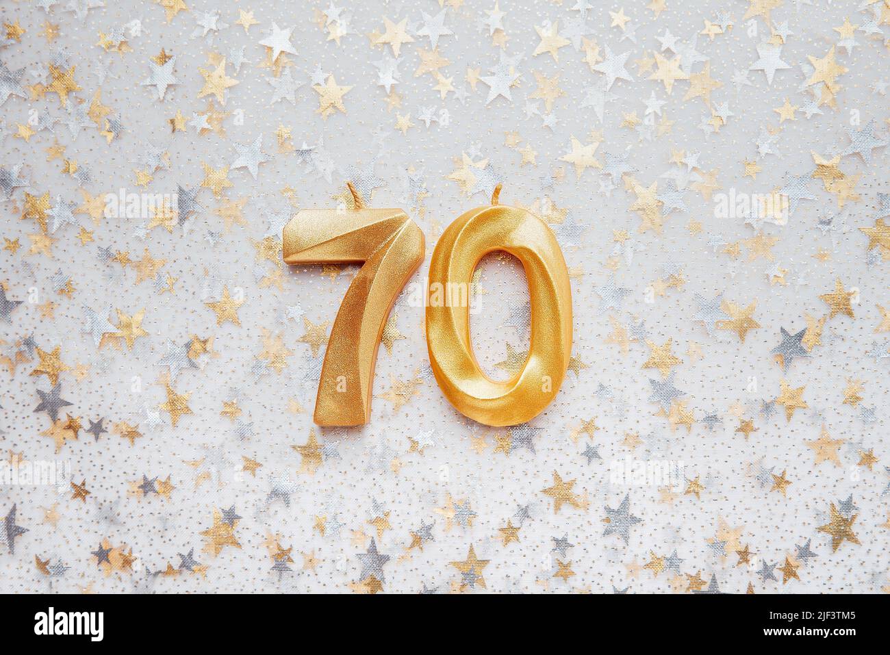 Number 70 seventy golden celebration birthday candle on Festive Background. seventy years birthday. concept of celebrating birthday, anniversary, important date, holiday Stock Photo