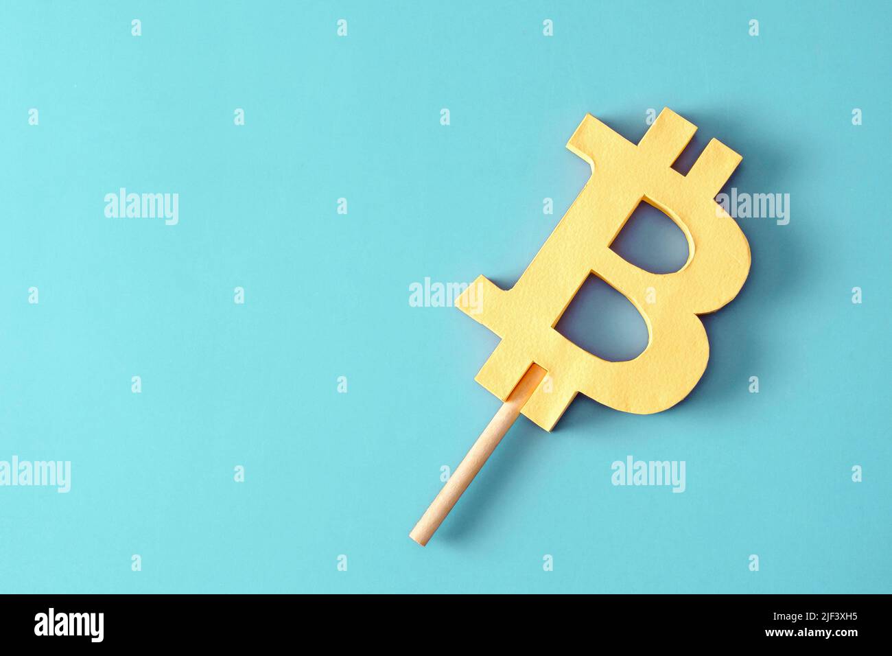 Bitcoin like ice cream on a stick minimal creative concept of profit and loss or success and risk in the cryptocurrency market with blockchain technol Stock Photo