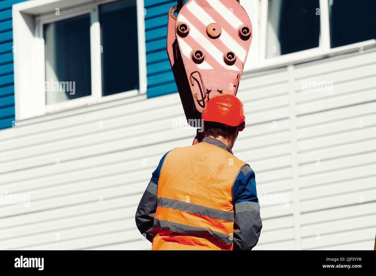 The slinger hooks the rope slings onto the hook of the truck crane Stock  Photo - Alamy