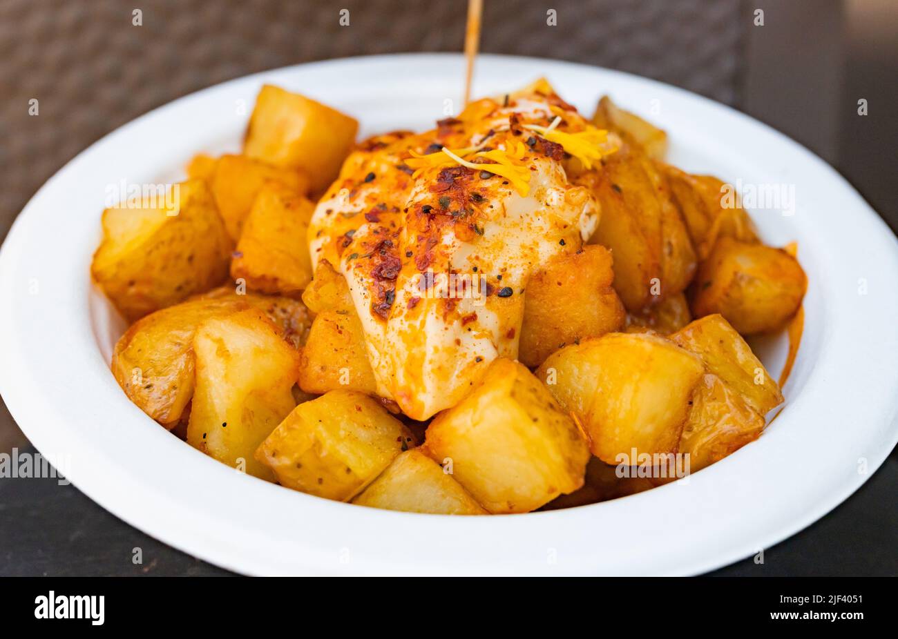 Traditional patatas bravas with aioli sauce, Spanish food, selective