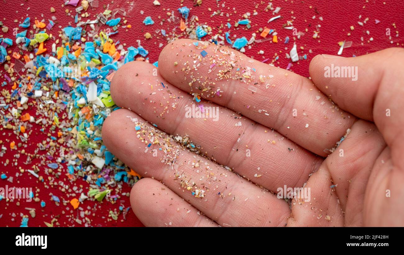 Closeup on micro plastic particles in a person's hand. Concept for