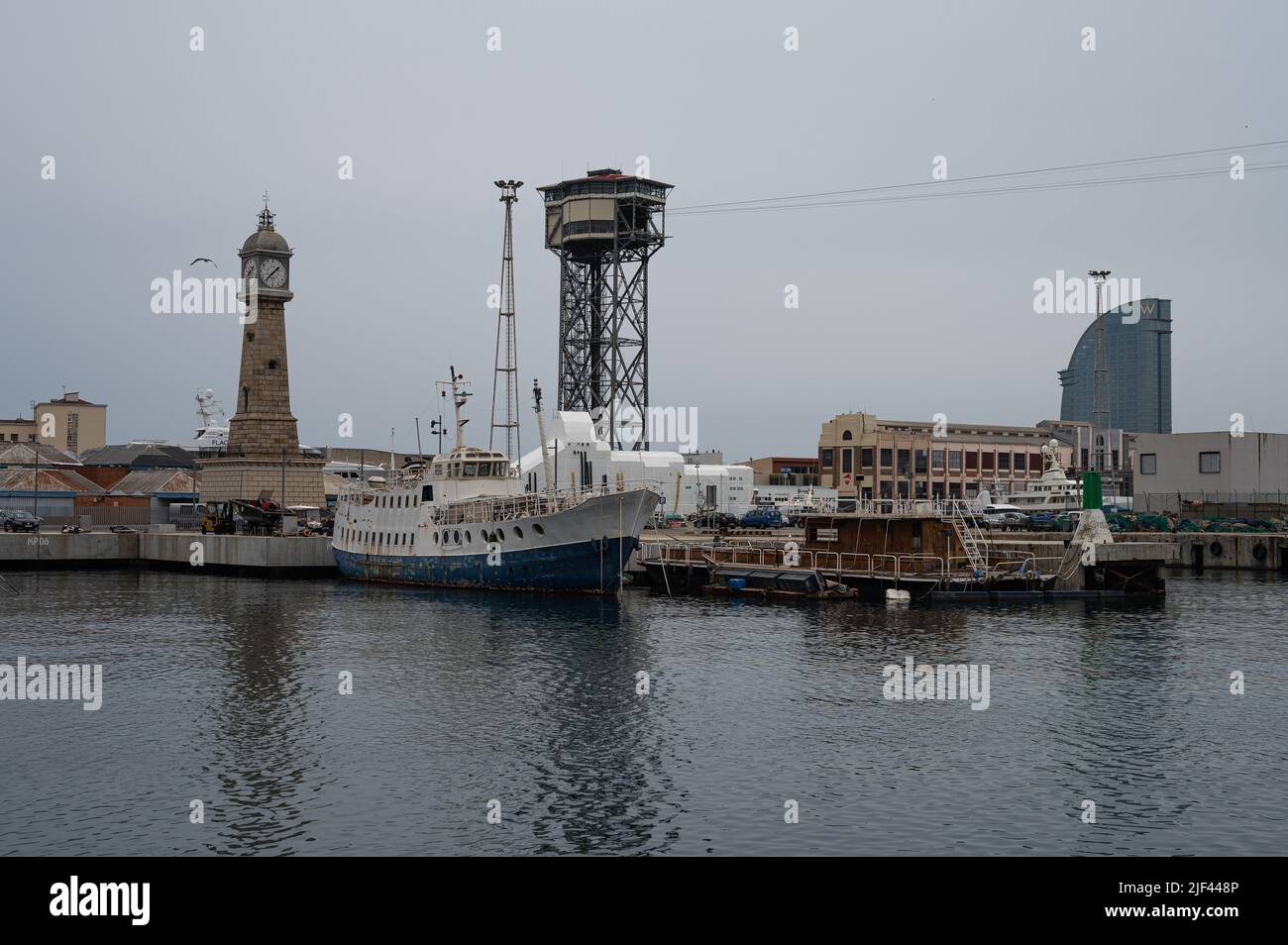 Photograph of the port of Barcelona with old ships, the cable car and the clock tower Stock Photo