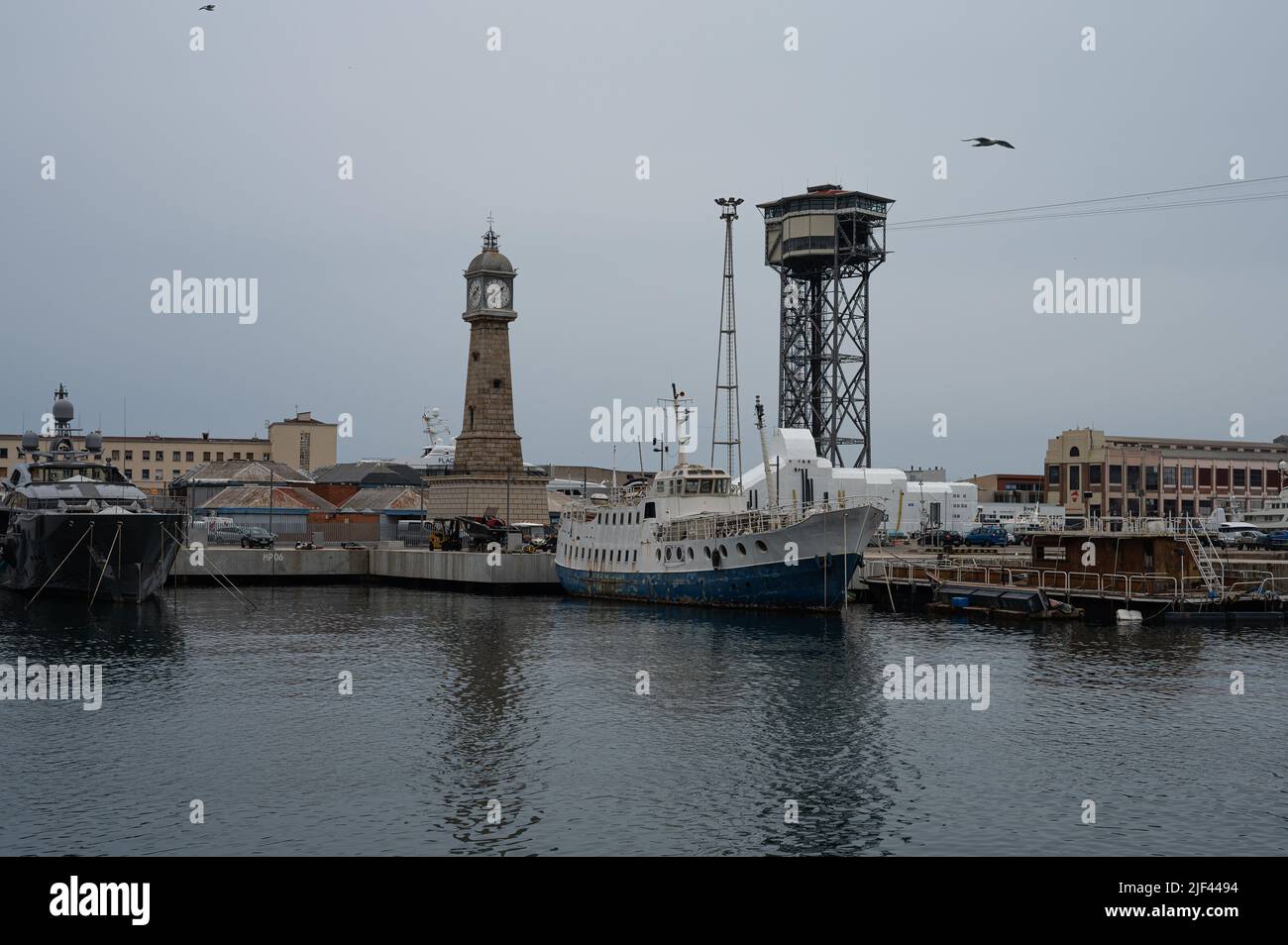 Photograph of the port of Barcelona with old ships, the cable car and the clock tower Stock Photo