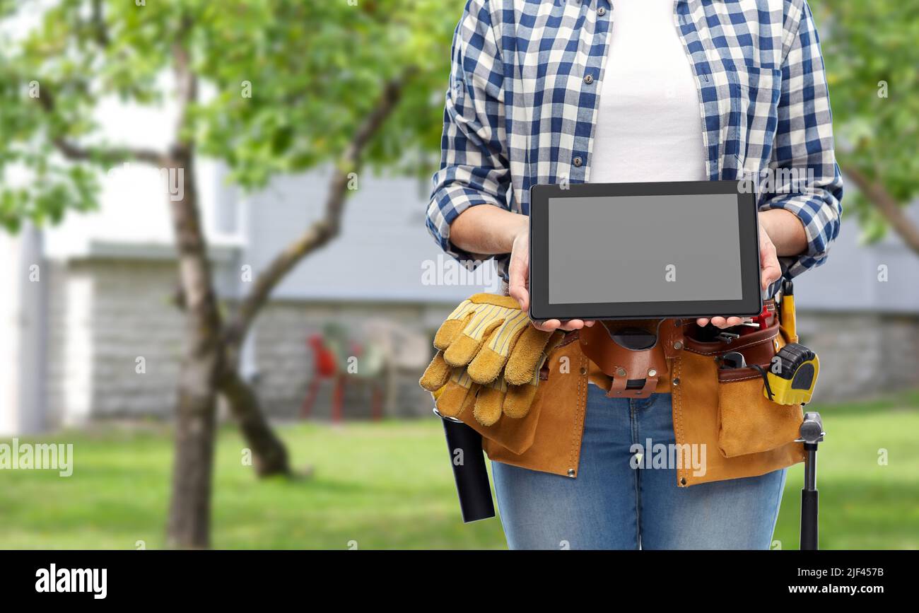 woman builder with working tools showing tablet pc Stock Photo
