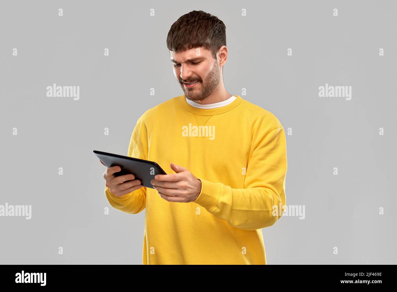 displeased young man with tablet pc computer Stock Photo