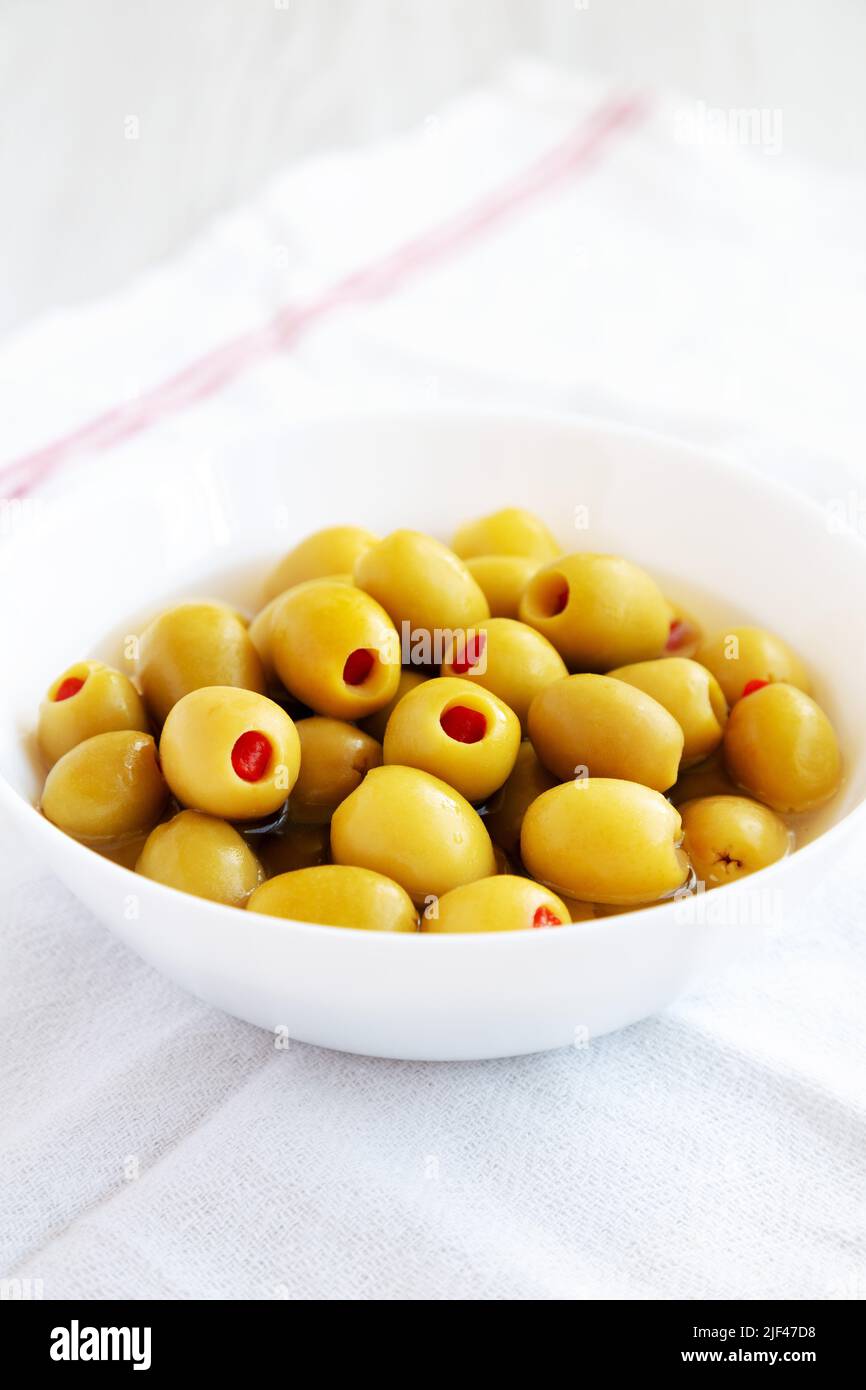 Marinated Green Olives with Pimento Peppers in a Bowl, side view Stock