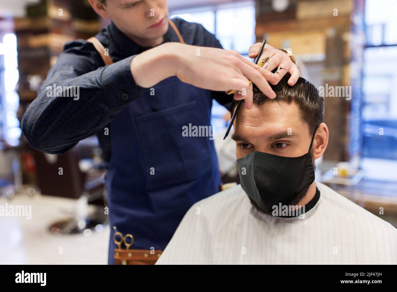 man and barber cutting hair at barbershop Stock Photo - Alamy