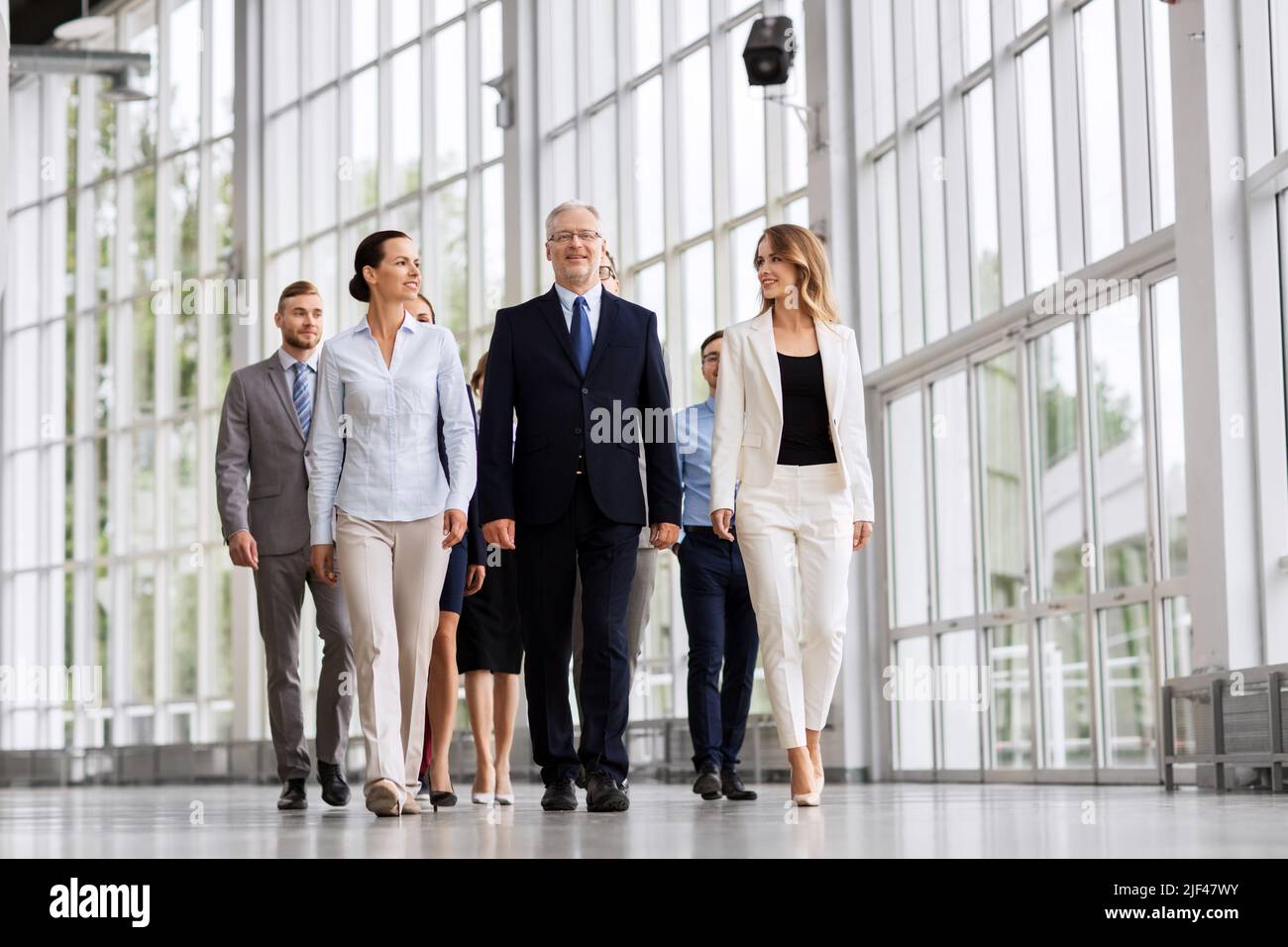 business people walking along office building Stock Photo - Alamy
