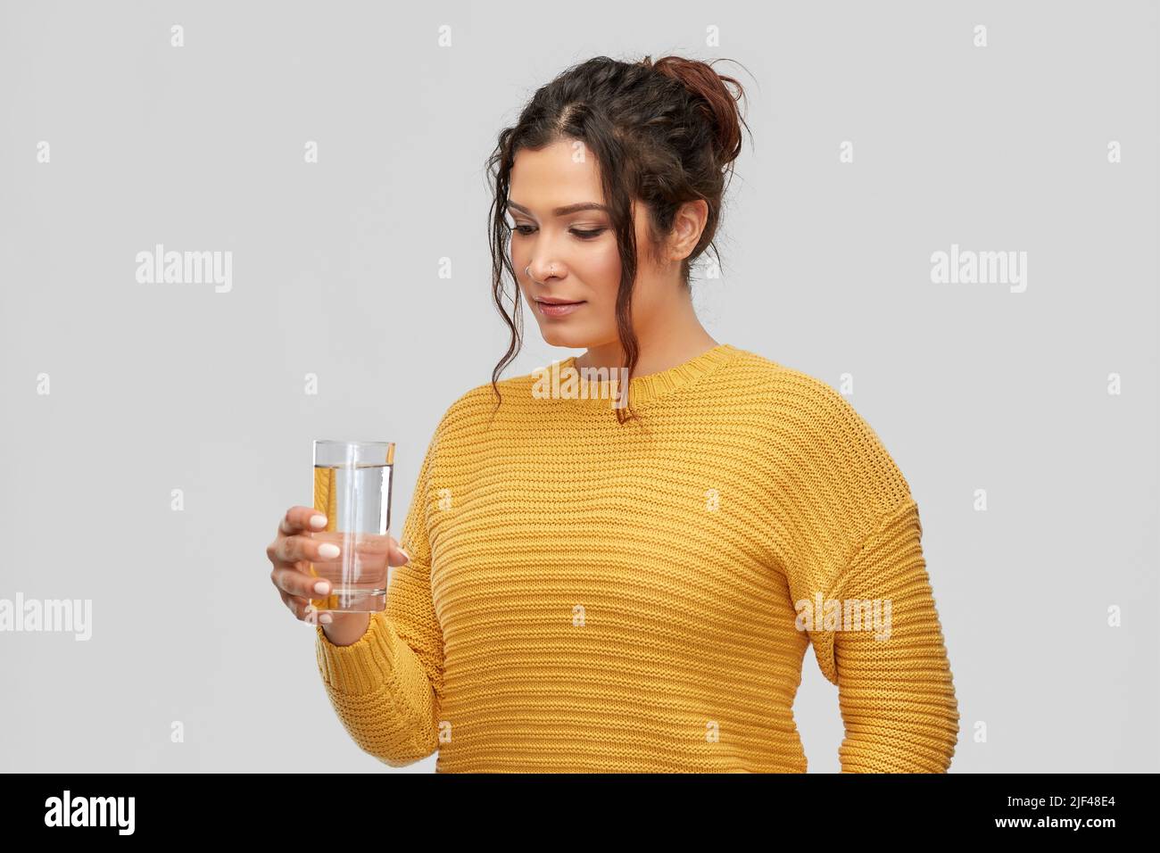 smiling young woman with water in glass Stock Photo