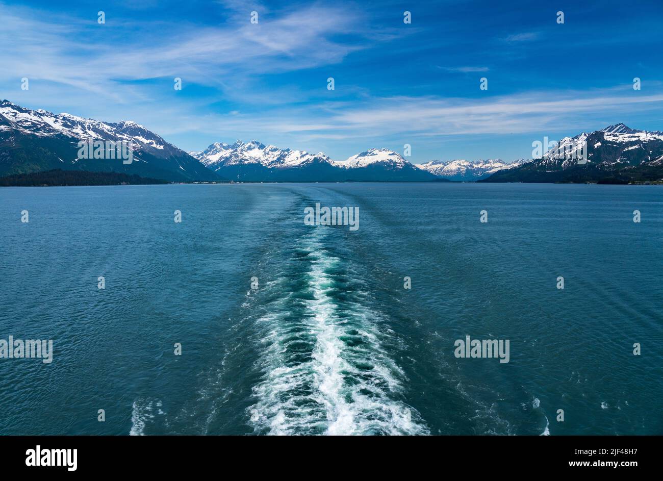 Wake from cruise ship sailing down the Prince William Sound away from Valdez in Alaska Stock Photo