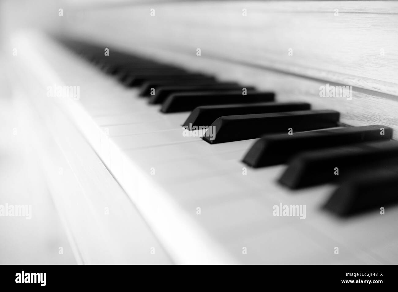 Bright white Piano keys on old musical instrument with high tone ebony and ivory close up Stock