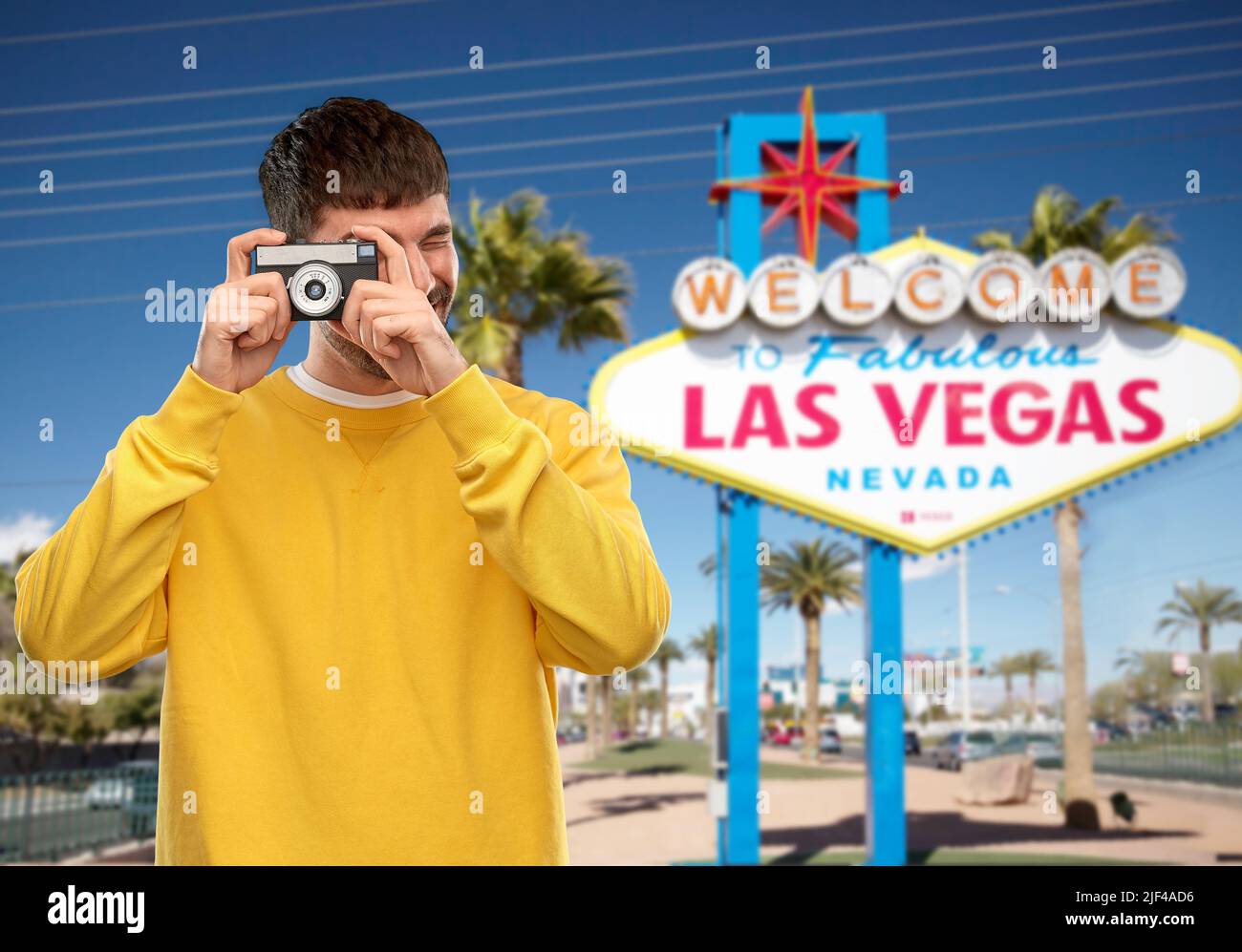 man with vintage film camera over las vegas sign Stock Photo Alamy