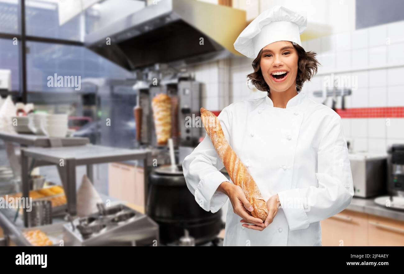 happy female chef with french bread or baguette Stock Photo - Alamy