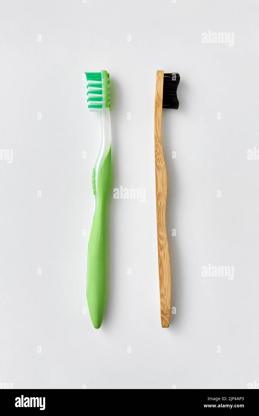 wooden and plastic toothbrush on white background Stock Photo - Alamy