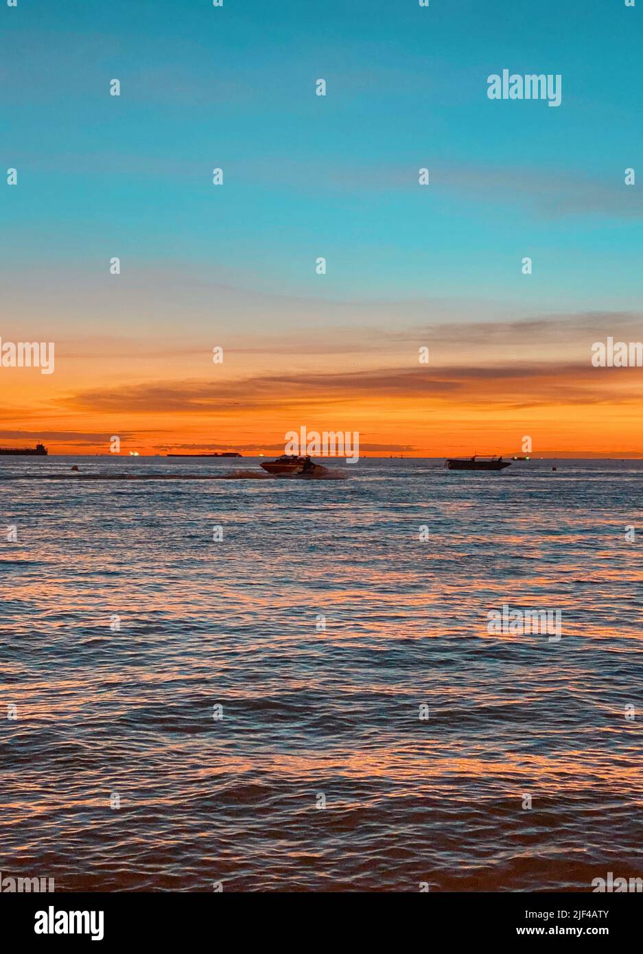 Colorful seascape, ships at sea during a beautiful sunset, rays of sun ...