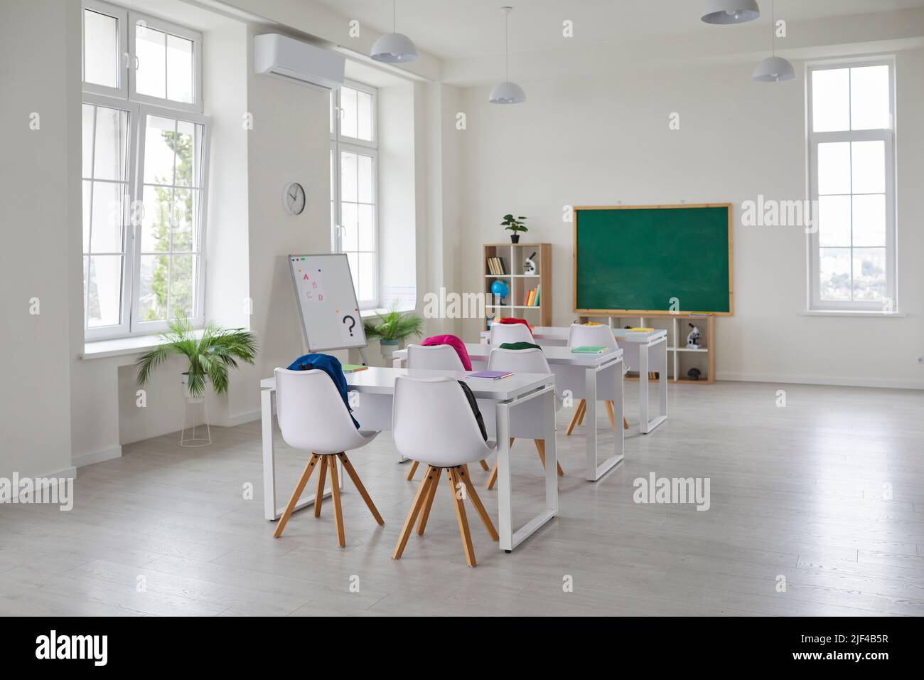 Interior of modern school classroom with desks, chairs, blackboard and whiteboard Stock Photo