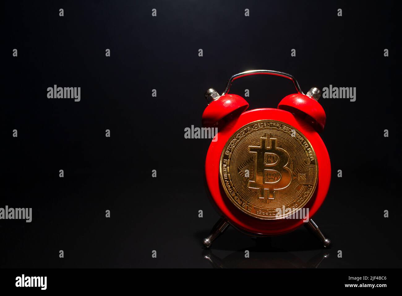 Bitcoin and alarm clock on black background. Deadline concept for investing  in bitcoin cryptocurrency. Copy space Stock Photo - Alamy