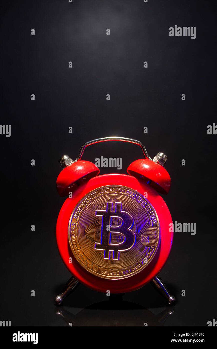 Bitcoin and alarm clock on black background. Deadline concept for investing  in bitcoin cryptocurrency. Copy space Stock Photo - Alamy