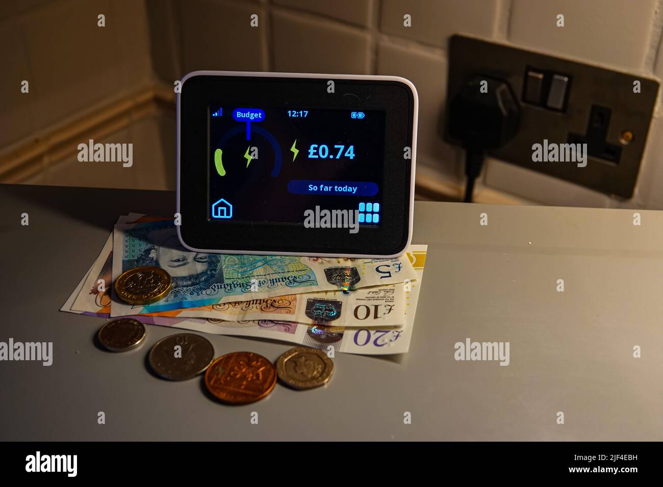 An electricity smart-meter, with plug socket, checking electricity usage, UK Stock Photo