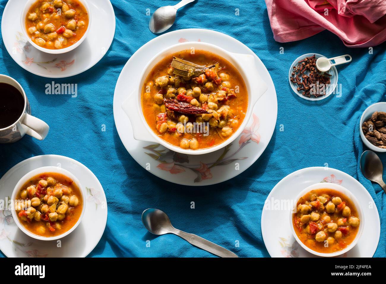 Top view of Chana Masala or Choley or Chickpea sauteed in butter or ghee on a dark blue background. Gravy is thick has onion,tomato.Punjabi,Pakistani. Stock Photo