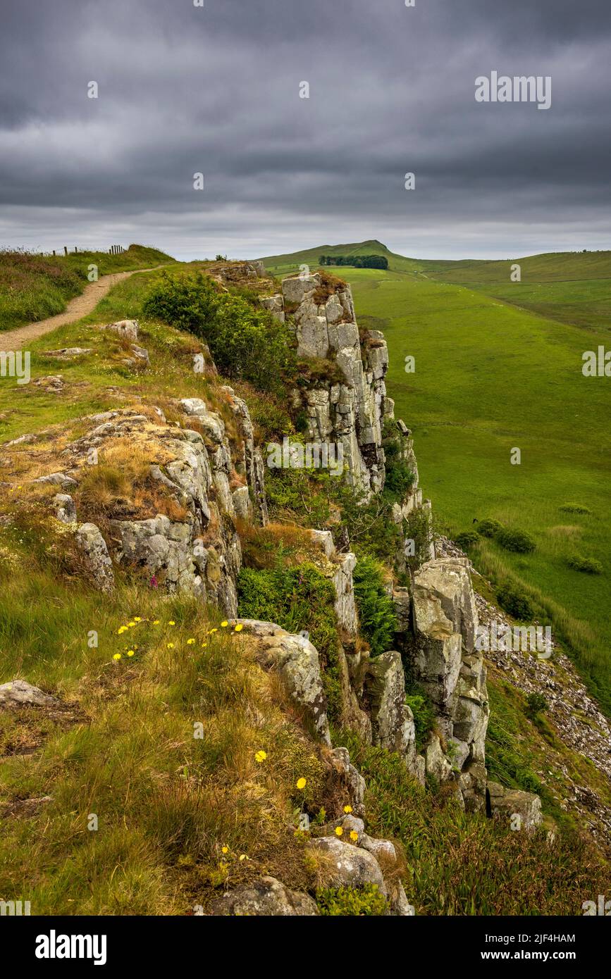 West along Hadrian’s Wall Path on top of Steel Rigg Crags, Northumberland, England Stock Photo