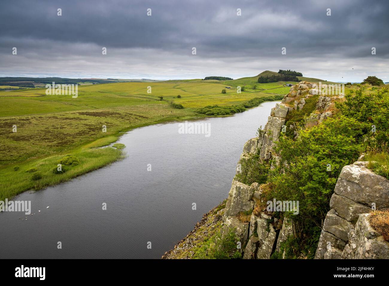 East along Hadrian’s Wall Path on top of Steel Rigg Crags with Crag Lough below, Northumberland, England Stock Photo