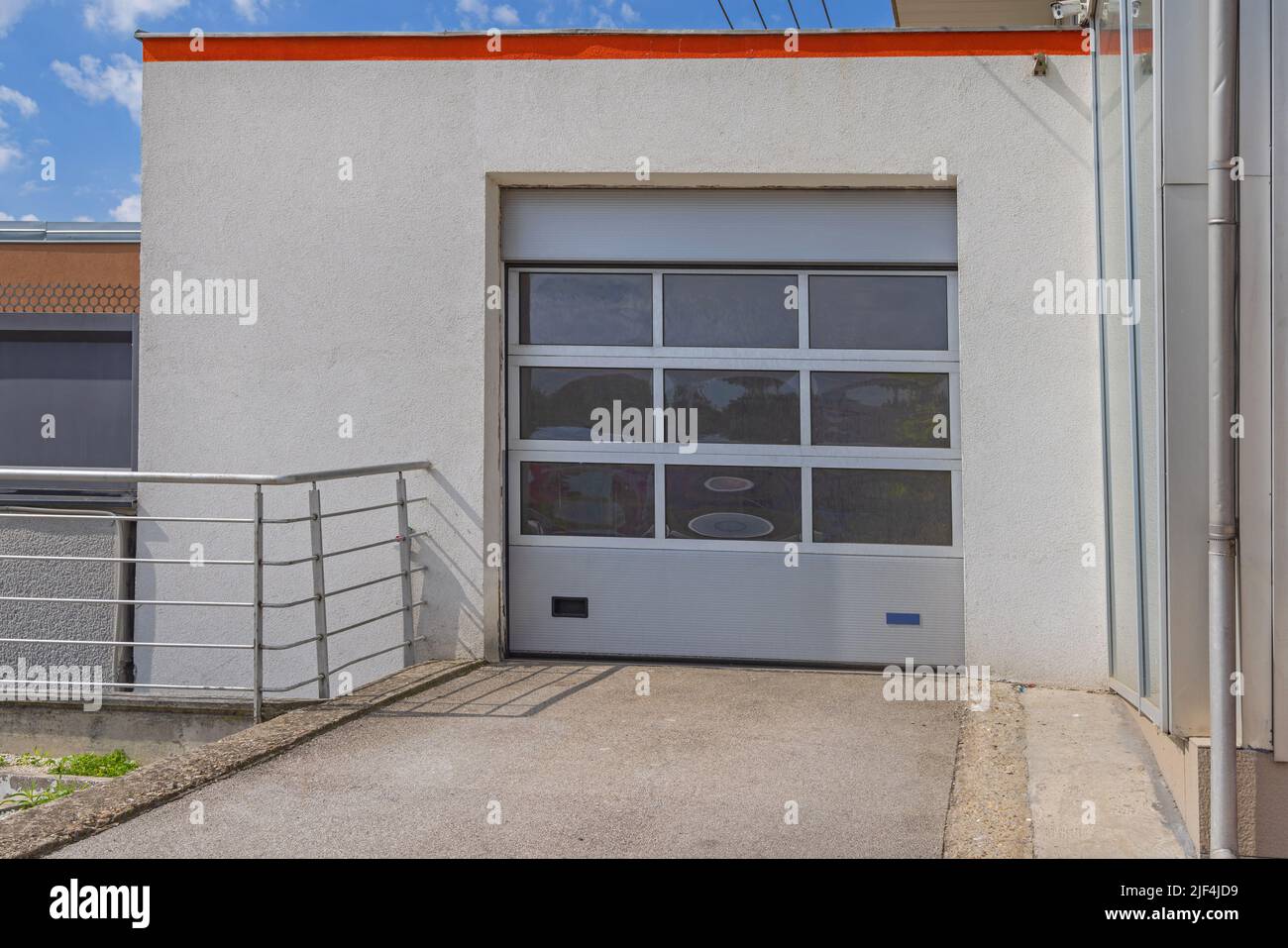 Electric Garage Sectional Roller Doors With Glass Windows Stock Photo