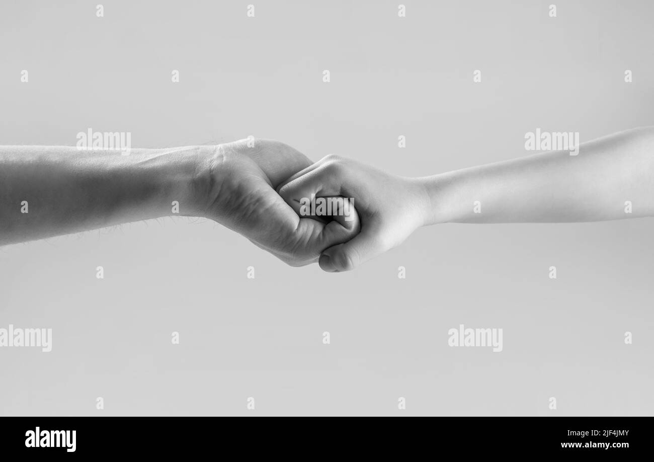 Woman and kid hands connect with each other. Friendly handshake