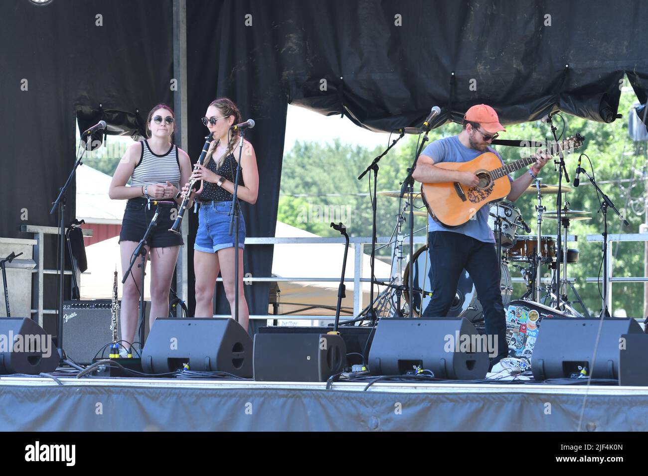 Musician Matthew Fowler is shown performing on stage during a “live” concert appearance at the Green River Festival. Stock Photo