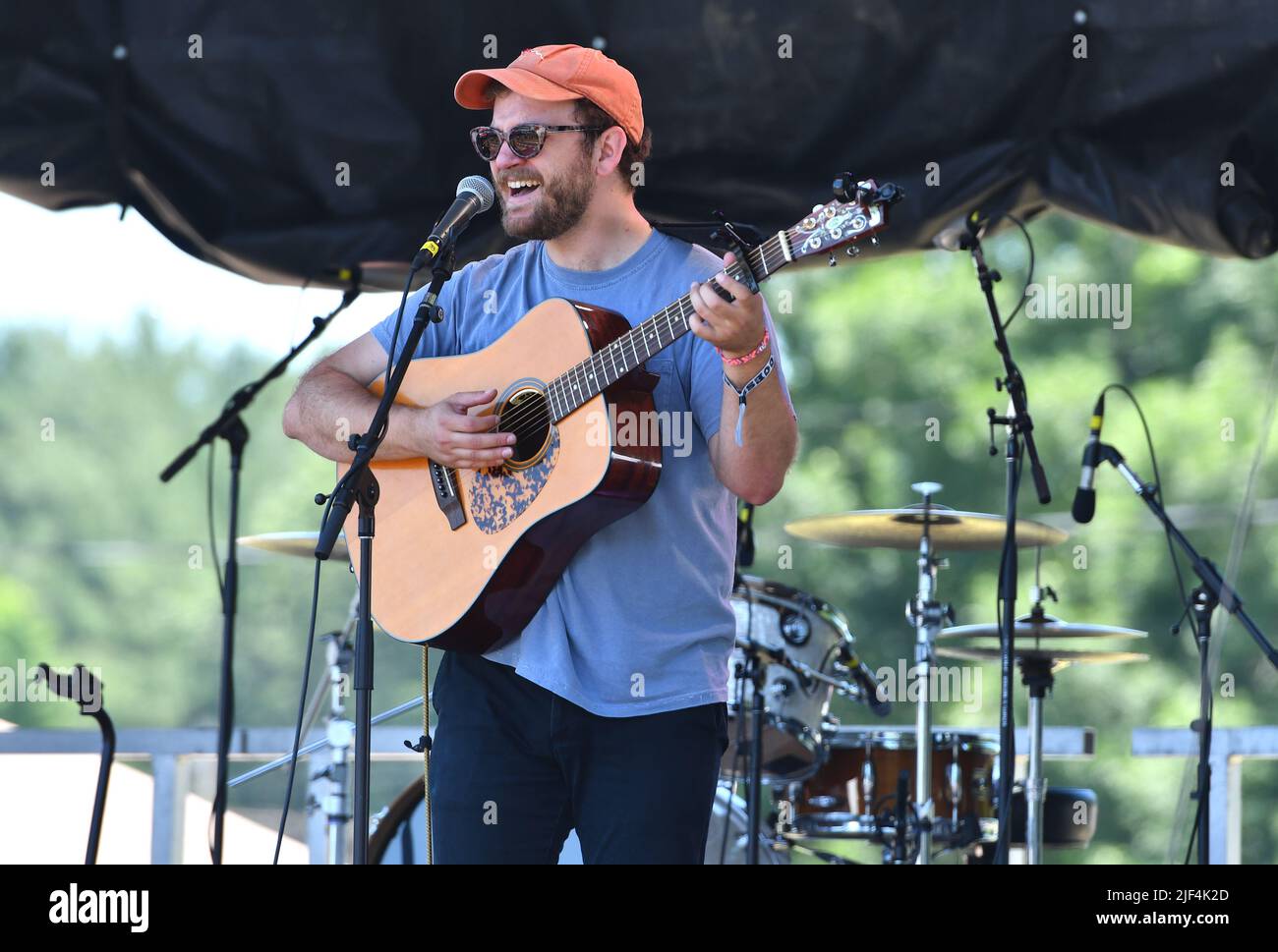 Musician Matthew Fowler is shown performing on stage during a “live” concert appearance at the Green River Festival. Stock Photo