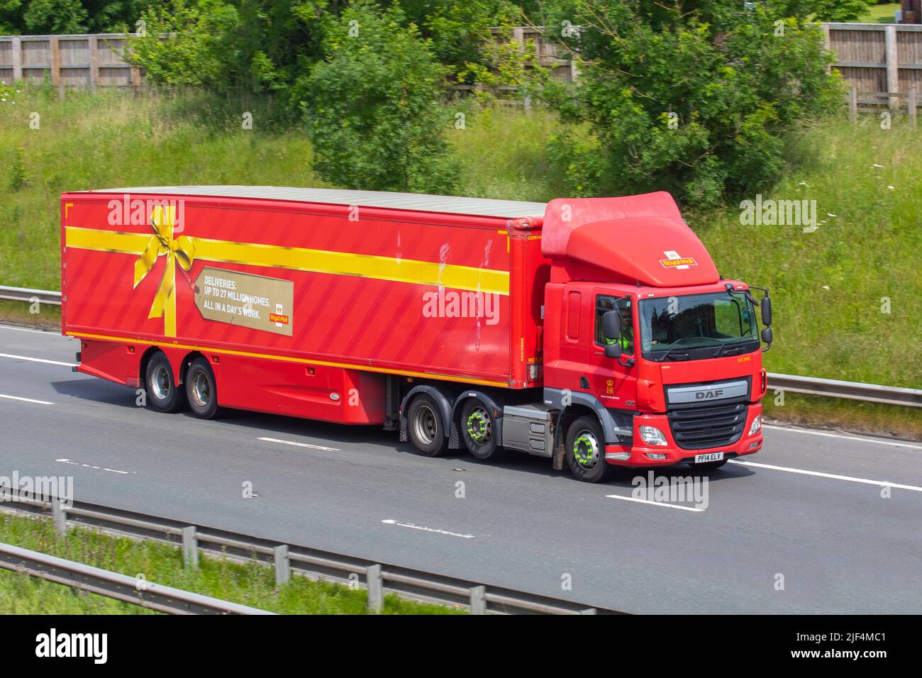 Royal Mail, Parcel Force 2014  DAF Trucks 10837cc Diesel large, long delivery vehicle. Yellow Ribbon Christmas parcel wrapping livery lorry traveling on the M61 motorway near Manchester, UK Stock Photo