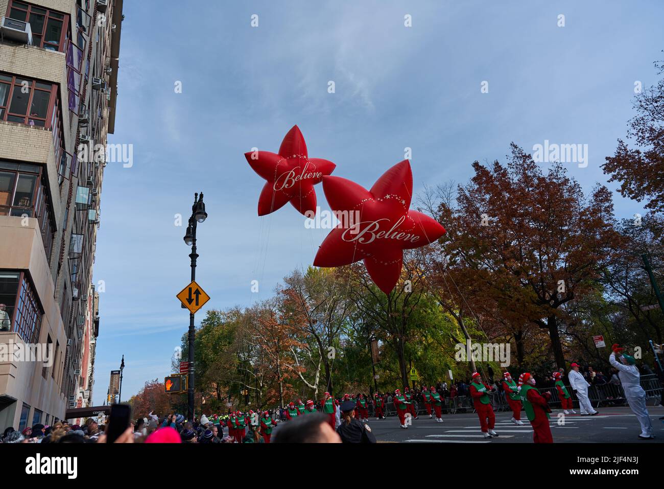 Manhattan, USA - 24. November 2021: Macy's Parade Balloons, Red Stars with Believe text. Thanksgiving Parade Stock Photo