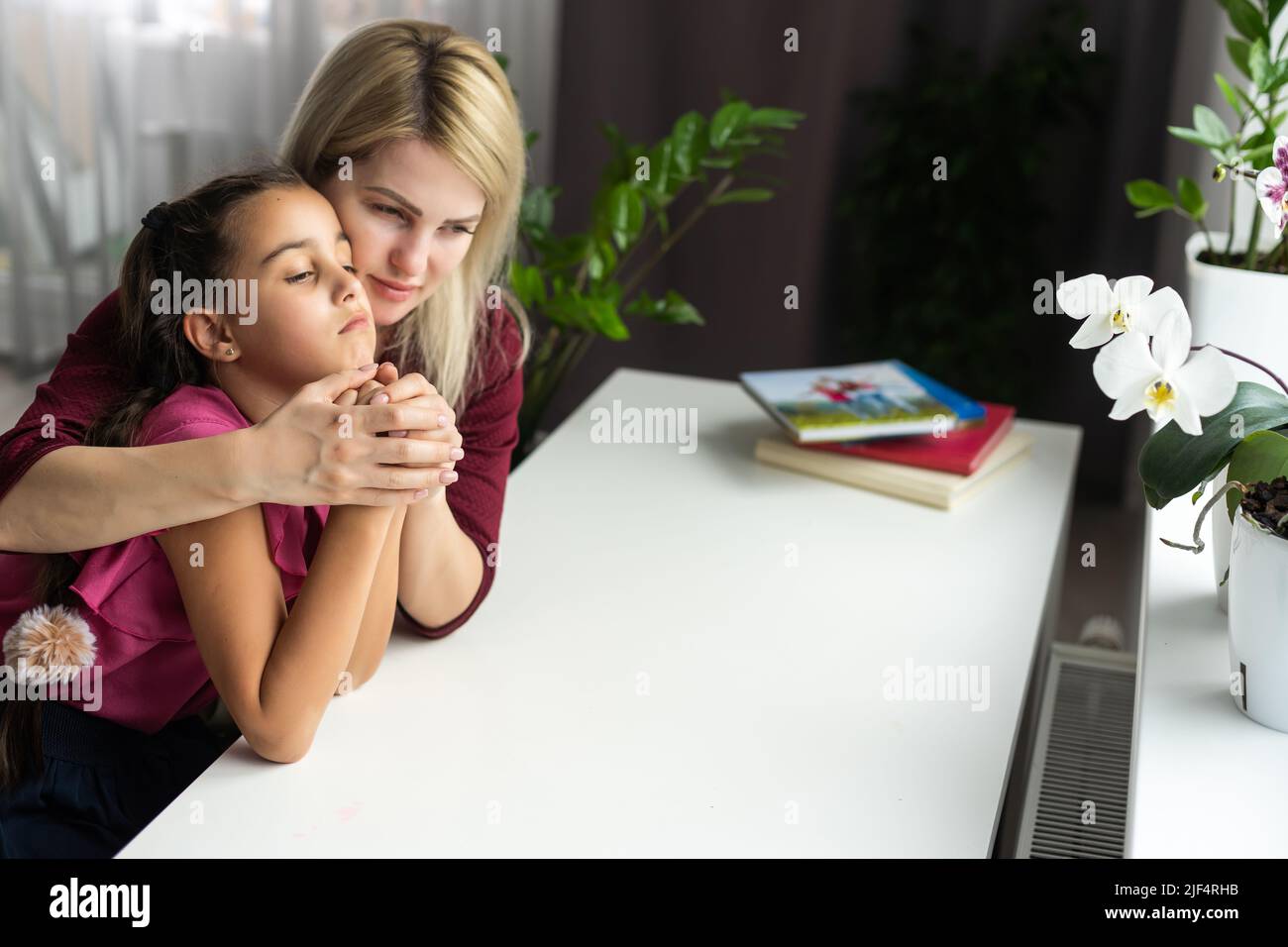 Religious Christian girl praying with her mother indoors Stock Photo ...