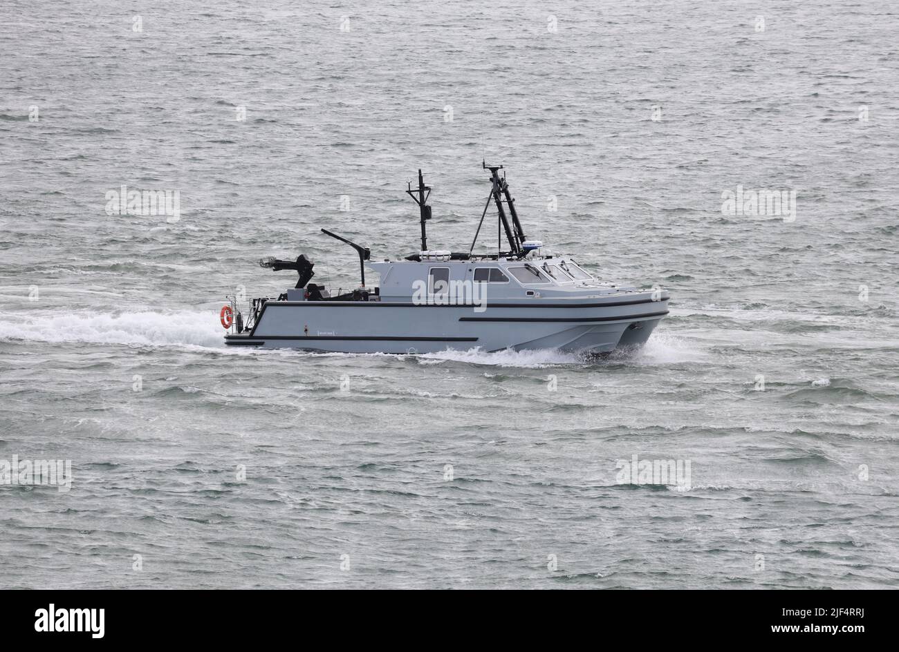 The Royal Navy’s new autonomous surface vessel RNMB HEBE approaches the Naval Base Stock Photo